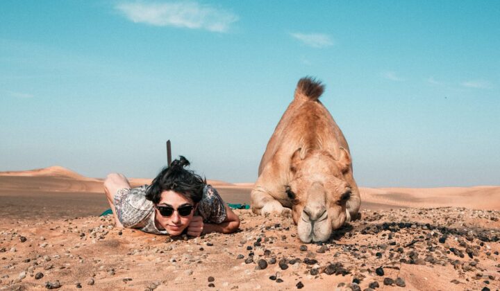 person posing with a camel